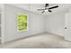 Bright bedroom with neutral carpet features a ceiling fan and a window offering outdoor views at 1457 Mandy Place Ct, Charlotte, NC 28216