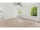Bright bedroom featuring wood-look floors, ceiling fan and natural light at 1457 Mandy Place Ct, Charlotte, NC 28216