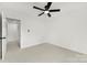 This bright carpeted bedroom includes a ceiling fan and access to an ensuite bathroom at 1457 Mandy Place Ct, Charlotte, NC 28216