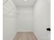 Walk-in closet with wire shelving, light wood flooring, and neutral paint colors at 1457 Mandy Place Ct, Charlotte, NC 28216