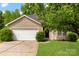 Charming single-Gathering home featuring a one-car garage, a manicured lawn, and a welcoming front entrance at 1457 Mandy Place Ct, Charlotte, NC 28216