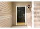 Close-up of a dark front door with decorative hardware, set in a neutral-toned siding with traditional exterior lighting at 1457 Mandy Place Ct, Charlotte, NC 28216