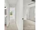 Bright hallway featuring neutral carpet and white walls connects living spaces and bathroom at 1457 Mandy Place Ct, Charlotte, NC 28216