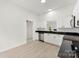 Bright, modern kitchen featuring white cabinets, stainless steel appliances, and black countertops at 1457 Mandy Place Ct, Charlotte, NC 28216