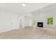 Bright living room featuring a fireplace, wood-look floors, and natural light at 1457 Mandy Place Ct, Charlotte, NC 28216