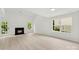 Bright living room featuring fireplace, wood-look floors, and natural light at 1457 Mandy Place Ct, Charlotte, NC 28216