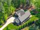 Aerial view showcasing the well-manicured lawn, landscape, and elegant driveway of this home at 1579 Sunset Pointe Dr, Salisbury, NC 28146