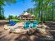 Backyard firepit area with Adirondack chairs in gravel setting, perfect for gathering at 1579 Sunset Pointe Dr, Salisbury, NC 28146