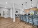 Entertaining bar area featuring stone accents, pendant lighting, bar seating and wood cabinetry at 1579 Sunset Pointe Dr, Salisbury, NC 28146