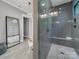 Modern bathroom featuring a glass-enclosed shower and a separate soaking tub at 1579 Sunset Pointe Dr, Salisbury, NC 28146