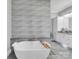 Luxurious bathroom featuring a freestanding tub, modern tilework, and dual vanities at 1579 Sunset Pointe Dr, Salisbury, NC 28146