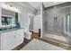 Modern bathroom with tiled shower, vanity with marble countertop and ample natural light at 1579 Sunset Pointe Dr, Salisbury, NC 28146