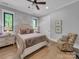 Spacious bedroom featuring hardwood floors, chair, and serene decor at 1579 Sunset Pointe Dr, Salisbury, NC 28146
