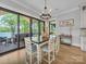 Bright dining area featuring a dark wood table and sliding glass doors to an outdoor space at 1579 Sunset Pointe Dr, Salisbury, NC 28146