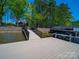 Dock with boat, calm lake and blue skies create relaxing waterfront retreat at 1579 Sunset Pointe Dr, Salisbury, NC 28146