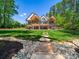 A grand home featuring a spacious backyard with an inviting stone pathway at 1579 Sunset Pointe Dr, Salisbury, NC 28146