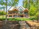Stunning lakefront home with multi-level balconies overlooking beautifully manicured lawn and waterfront at 1579 Sunset Pointe Dr, Salisbury, NC 28146