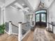 Grand foyer featuring a staircase, hardwood floors, decorative front door, and elegant lighting at 1579 Sunset Pointe Dr, Salisbury, NC 28146