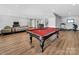Spacious game room featuring a pool table, living area, and access to the bar at 1579 Sunset Pointe Dr, Salisbury, NC 28146