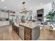 Open-concept kitchen featuring a large center island, stainless steel appliances, and views into the living area at 1579 Sunset Pointe Dr, Salisbury, NC 28146