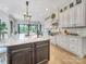 Spacious kitchen with a large center island, granite countertops, custom cabinets, and modern lighting fixtures at 1579 Sunset Pointe Dr, Salisbury, NC 28146