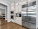 Modern kitchen featuring stainless steel appliances, white cabinetry, and hardwood floors at 1579 Sunset Pointe Dr, Salisbury, NC 28146