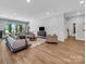 Spacious living room with large windows offering a scenic view and featuring modern furnishings at 1579 Sunset Pointe Dr, Salisbury, NC 28146