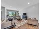 Comfortable living area featuring shiplap wall, modern furniture, hardwood floors, and scenic lake views at 1579 Sunset Pointe Dr, Salisbury, NC 28146