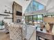 Sunlit living room featuring a stone fireplace, vaulted ceilings, sliding glass doors, and neutral-toned furniture at 1579 Sunset Pointe Dr, Salisbury, NC 28146