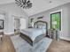 Bright bedroom with a decorative ceiling fan, large windows, and hardwood floors at 1579 Sunset Pointe Dr, Salisbury, NC 28146