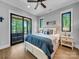 Inviting bedroom with a sliding glass door leading to a balcony with lake views at 1579 Sunset Pointe Dr, Salisbury, NC 28146