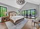 Spacious main bedroom with a decorative ceiling fan, access to deck, and natural light at 1579 Sunset Pointe Dr, Salisbury, NC 28146