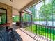 Overlook the lake from this covered porch with bench seating and greenery at 1579 Sunset Pointe Dr, Salisbury, NC 28146