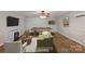 Basement featuring fireplace, a pool table, dartboard and sitting area; virtually staged at 160 Kingfisher Dr, Mooresville, NC 28117