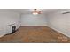 Spacious unfinished basement with concrete floors and a fireplace at 160 Kingfisher Dr, Mooresville, NC 28117