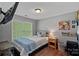 Cozy bedroom with hardwood floors, colorful dog art, and ample natural light at 160 Kingfisher Dr, Mooresville, NC 28117