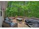 Outdoor deck with furniture, grill, and hot tub with a wooded view at 160 Kingfisher Dr, Mooresville, NC 28117