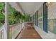 Relaxing front porch featuring a wooden swing, white railings, and hanging plants for a serene outdoor space at 160 Kingfisher Dr, Mooresville, NC 28117