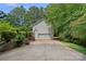 Detached two-car garage with basketball hoop, set back in trees at 160 Kingfisher Dr, Mooresville, NC 28117