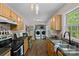 Bright kitchen with stainless steel appliances, wood cabinets and adjacent laundry area at 160 Kingfisher Dr, Mooresville, NC 28117