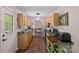 Charming kitchen with wood cabinets, stainless steel appliances, and view into dining area at 160 Kingfisher Dr, Mooresville, NC 28117