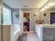 Bright bathroom boasting dual sink vanity, soaking tub, and neutral-toned tile flooring at 1715 Colin Creek Ln, Charlotte, NC 28214