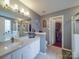 Bright bathroom boasting dual sink vanity, soaking tub, walk-in shower and neutral-toned tile flooring at 1715 Colin Creek Ln, Charlotte, NC 28214