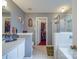 This bathroom features a soaking tub, walk-in shower and opens to the walk-in closet at 1715 Colin Creek Ln, Charlotte, NC 28214