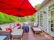 Inviting deck offers a place to relax with an outdoor seating set and a shade umbrella at 1715 Colin Creek Ln, Charlotte, NC 28214