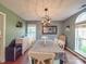Bright dining room featuring a modern light fixture and a large window, perfect for Gathering meals at 1715 Colin Creek Ln, Charlotte, NC 28214