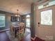 Bright dining area with modern chandelier, wood floors, and a view to the entryway at 1715 Colin Creek Ln, Charlotte, NC 28214