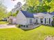 Charming one-story home with an attached garage and a beautifully landscaped front yard at 1715 Colin Creek Ln, Charlotte, NC 28214