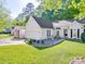 Charming one-story home with an attached garage and a beautifully landscaped front yard at 1715 Colin Creek Ln, Charlotte, NC 28214