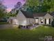 Charming single-story home boasts a well-manicured lawn, landscaped garden, and attached garage, perfect for suburban living at 1715 Colin Creek Ln, Charlotte, NC 28214